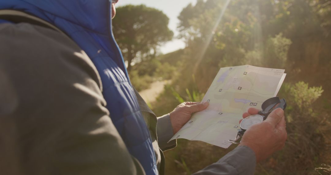 Man Holding Map and Compass on Outdoor Trek - Free Images, Stock Photos and Pictures on Pikwizard.com