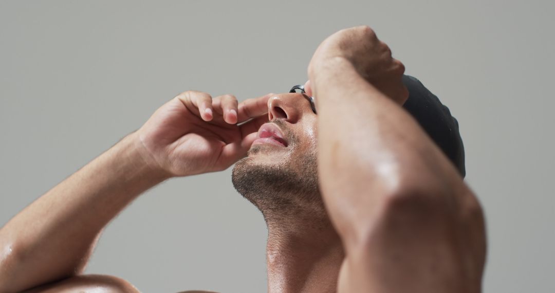 Focused Swimmer Preparing with Swim Goggles in Indoor Pool Race