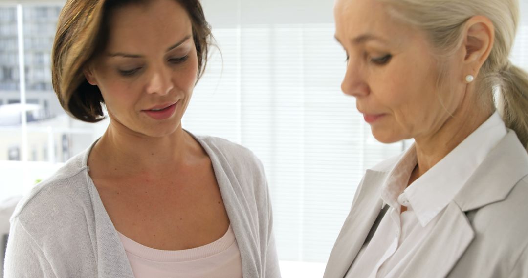 Women Engaged in Professional Conversation with Copy Space