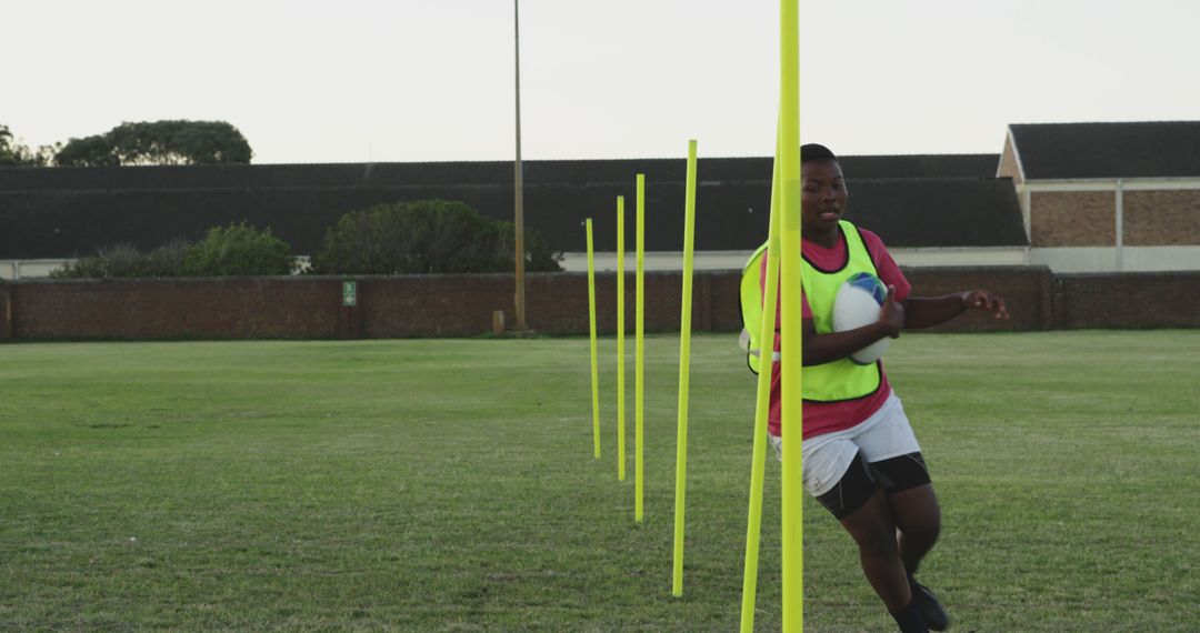 Young Rugby Player Training on Field with Training Cone - Free Images, Stock Photos and Pictures on Pikwizard.com