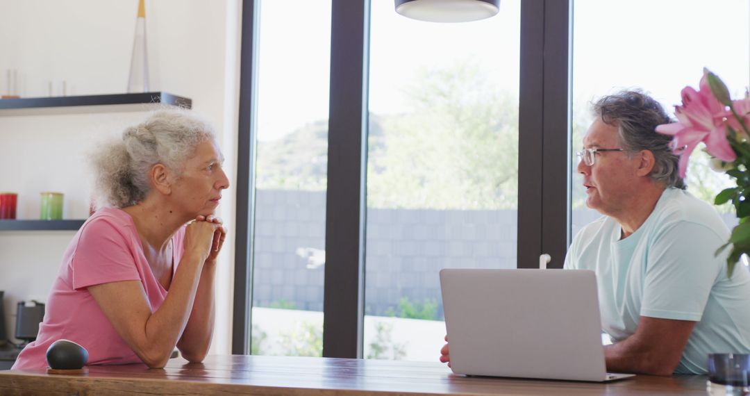 Senior Couple Enjoys Technology and Conversation at Home