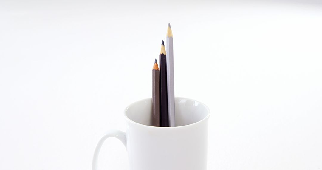 Colored Pencils in White Mug on Minimalist Background - Free Images, Stock Photos and Pictures on Pikwizard.com