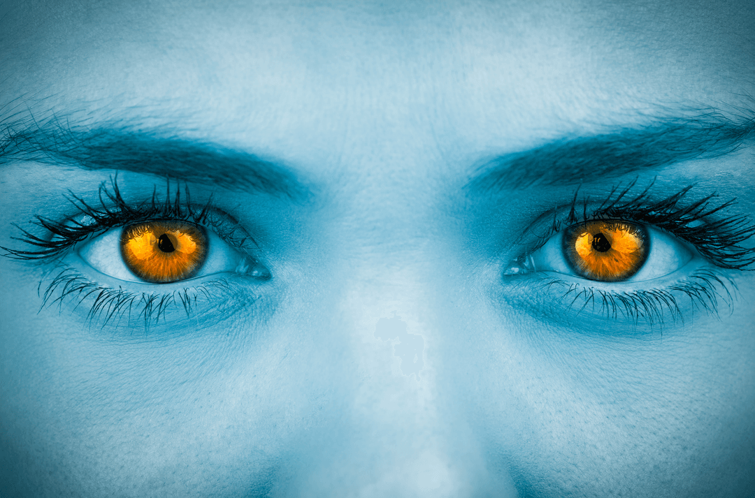 Close-up of Face with Transparent Orange Eyes and Blue Hue