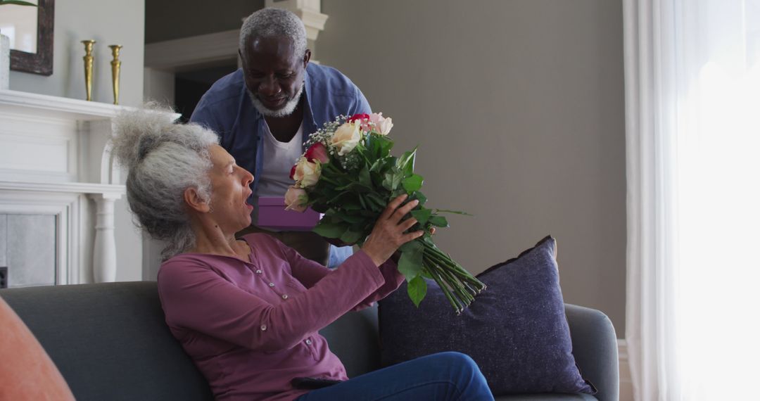 Elderly Man Giving Bouquet to Woman in Cozy Living Room - Free Images, Stock Photos and Pictures on Pikwizard.com