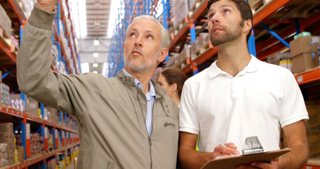 Warehouse Supervisor Training New Employee During Inventory Inspection - Free Images, Stock Photos and Pictures on Pikwizard.com