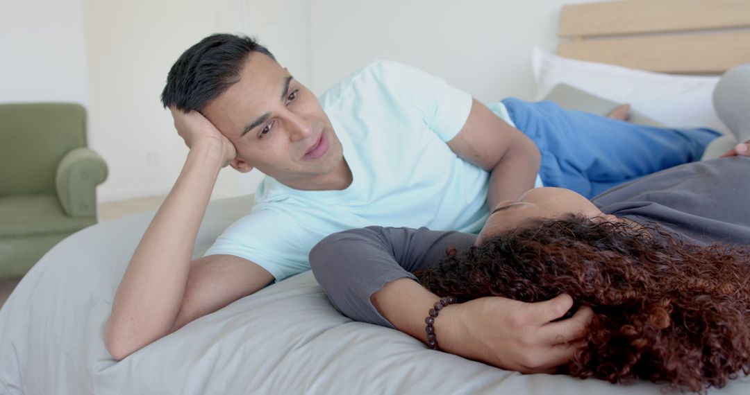 Happy Diverse Gay Couple Relaxing on Bed at Home
