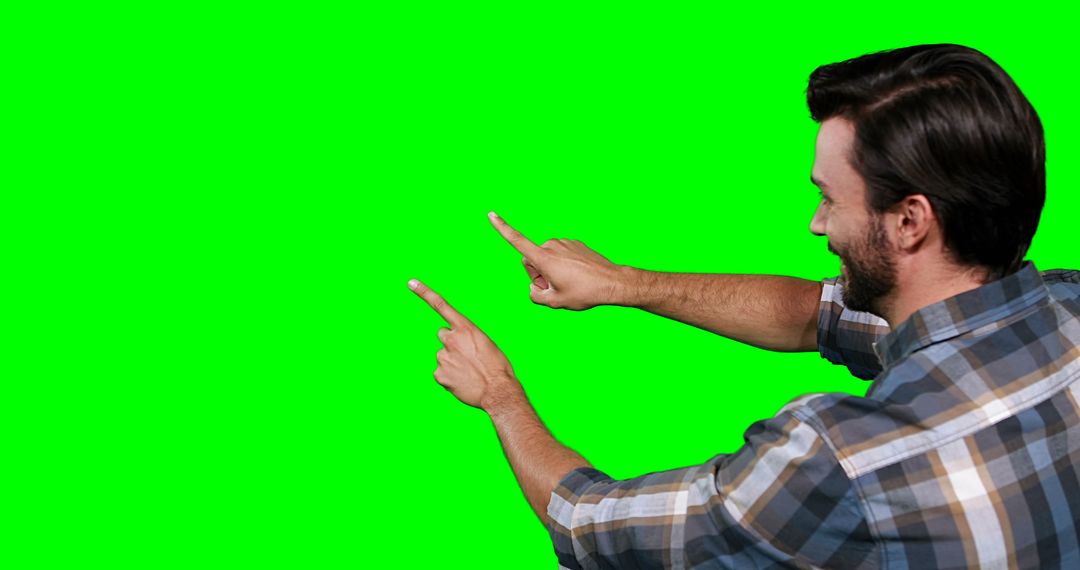 Man Pointing at Copy Space on Green Screen Background - Free Images, Stock Photos and Pictures on Pikwizard.com