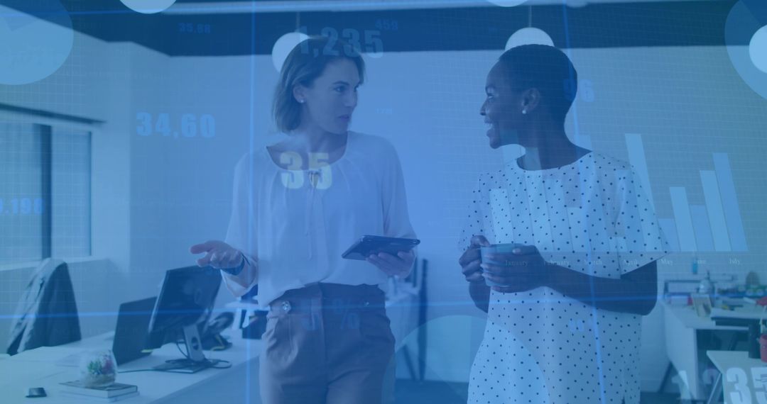 Businesswomen Discussing Analytics in Modern Office Environment