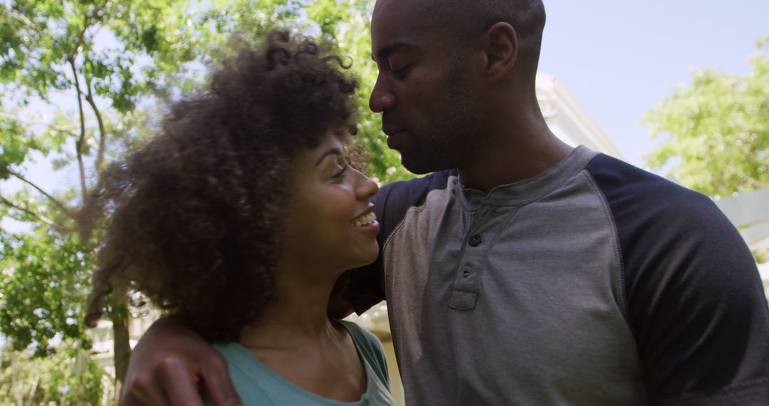 Happy Couple Embracing in Sunny Garden Setting