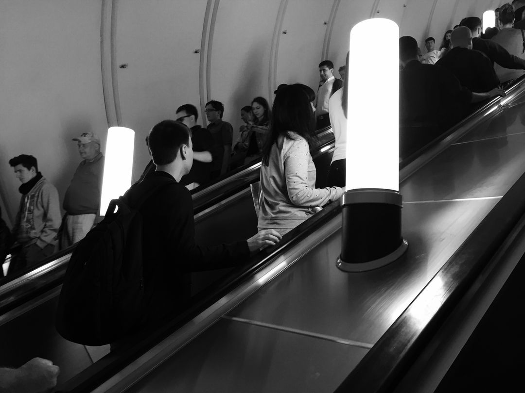 People Riding Escalator in Tunnel with Bright Lights - Free Images, Stock Photos and Pictures on Pikwizard.com