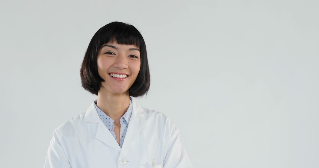 Smiling Female Doctor in White Coat with Confident Expression - Free Images, Stock Photos and Pictures on Pikwizard.com