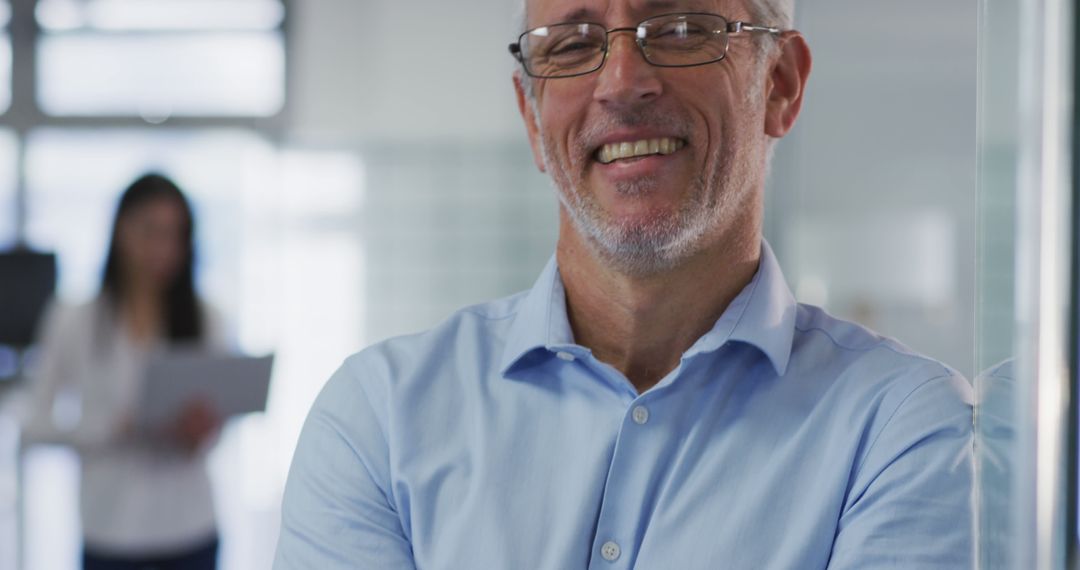 Confident Middle-aged Man Smiling in Modern Office - Free Images, Stock Photos and Pictures on Pikwizard.com