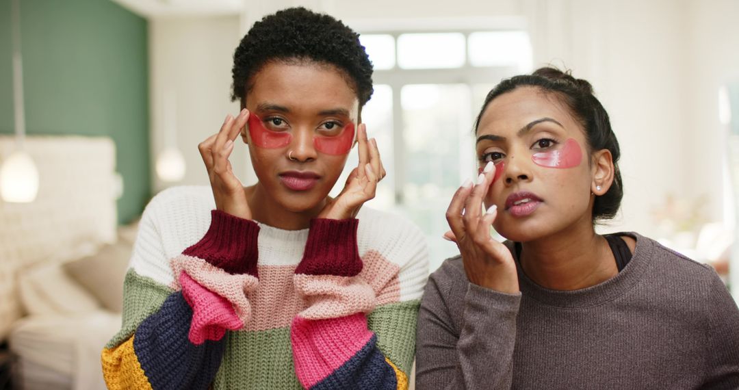Diverse Women Relaxing With Pink Under-Eye Patches in Softly Lit Room