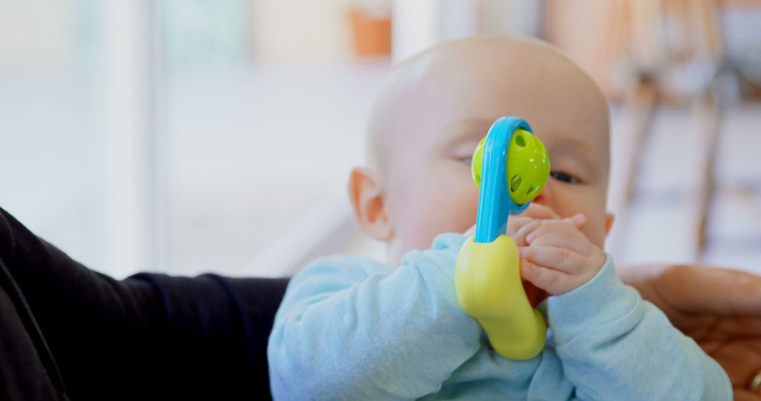 Cute Baby Holding Colorful Rattle - Free Images, Stock Photos and Pictures on Pikwizard.com