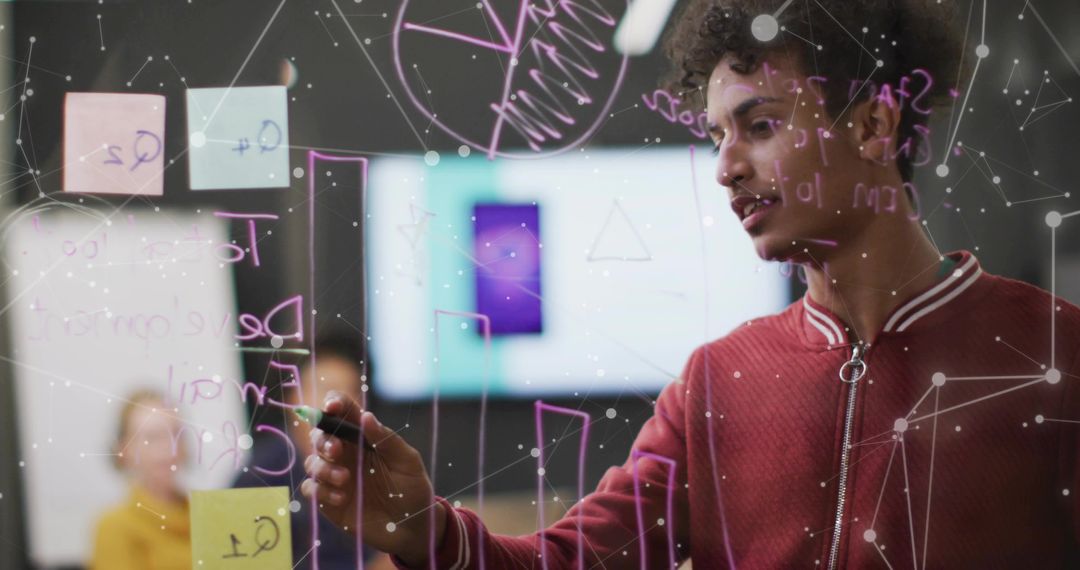 Developer Collaborating on Glass Board in Modern Office