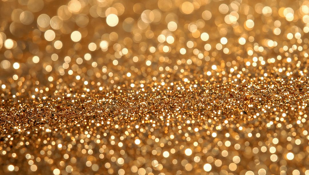 Sparkling gold glitter macro background with metallic flakes, bokeh and shimmer