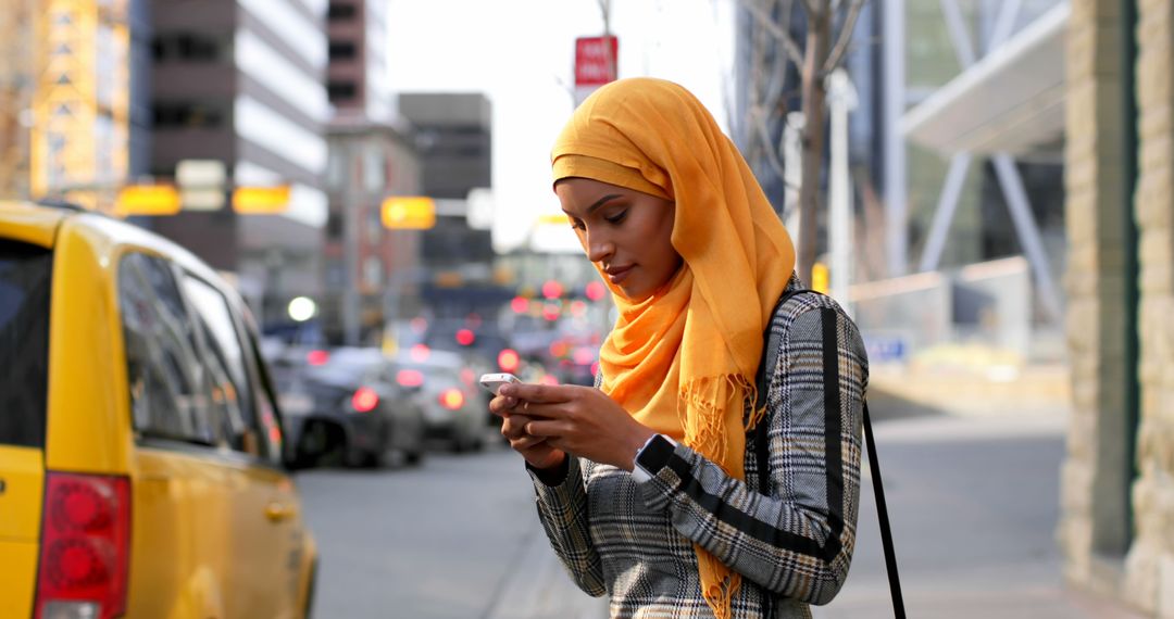 Young Muslim Woman Texting on City Street - Free Images, Stock Photos and Pictures on Pikwizard.com