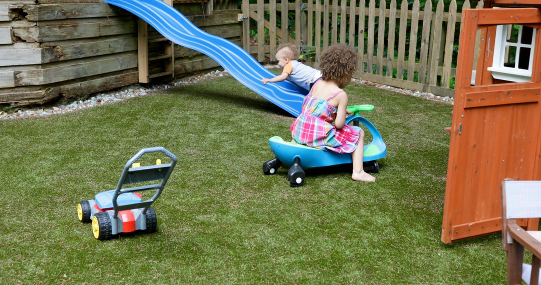 Children Playing in Garden with Toys and Slide - Free Images, Stock Photos and Pictures on Pikwizard.com