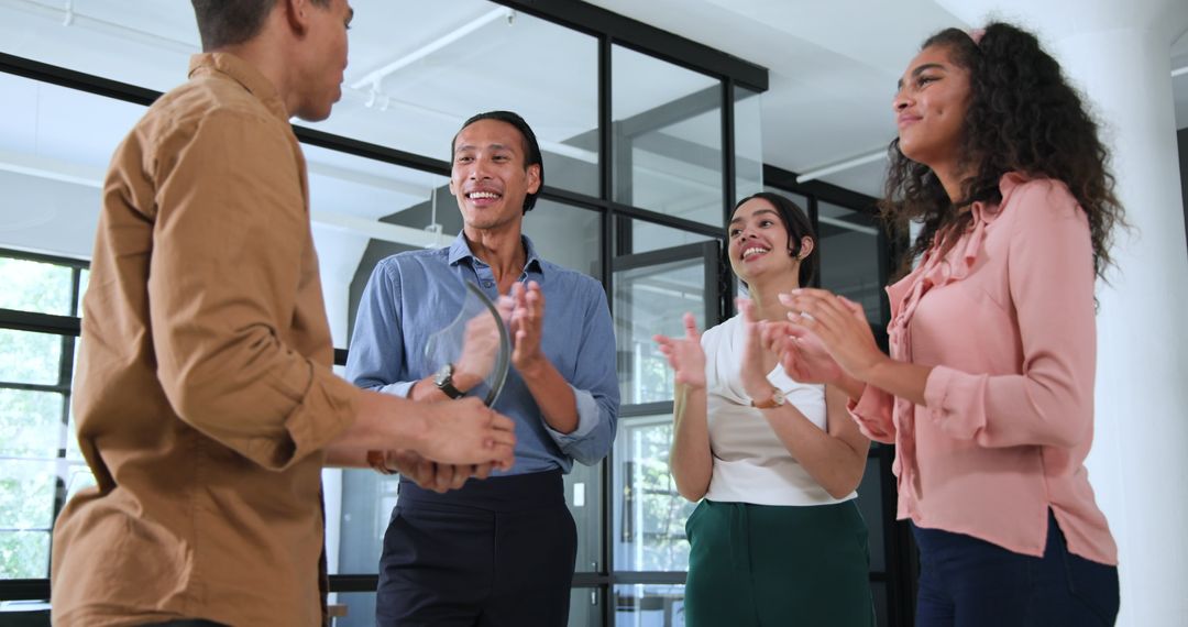 Ecstatic Team Celebrating Successful Colleague Achievement in Modern Office