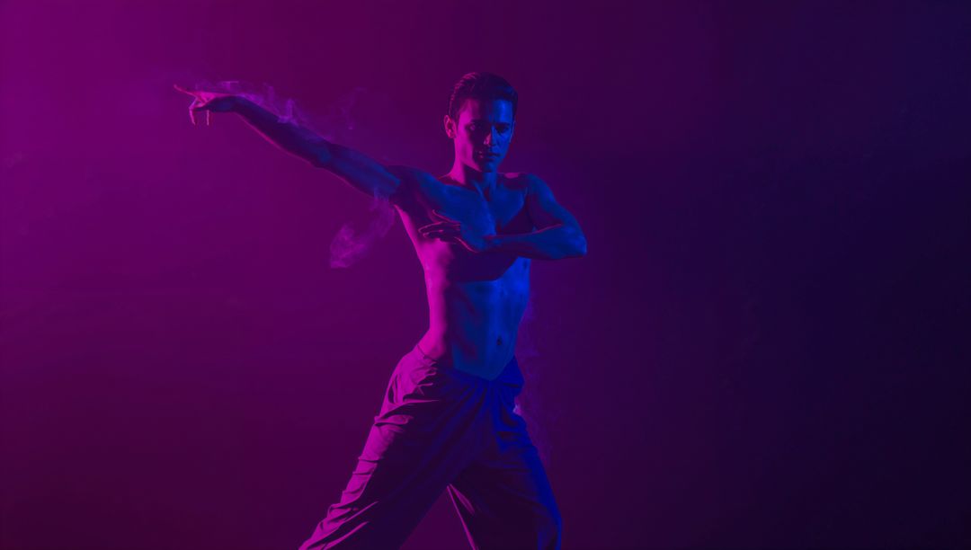 Shirtless Male Dancer Posing in Dynamic Lighting Effect