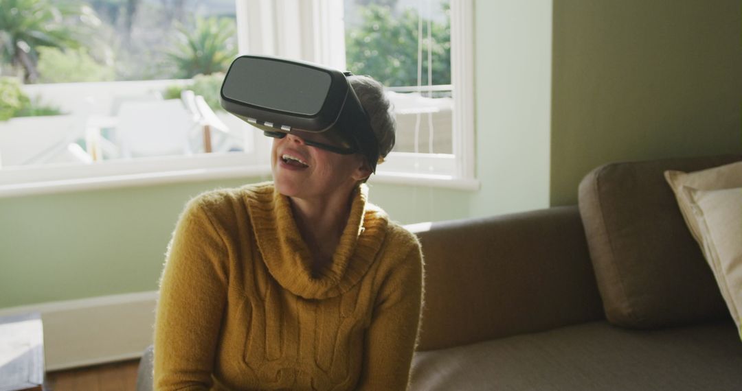 Excited Senior Woman Using Virtual Reality Headset in Living Room - Free Images, Stock Photos and Pictures on Pikwizard.com