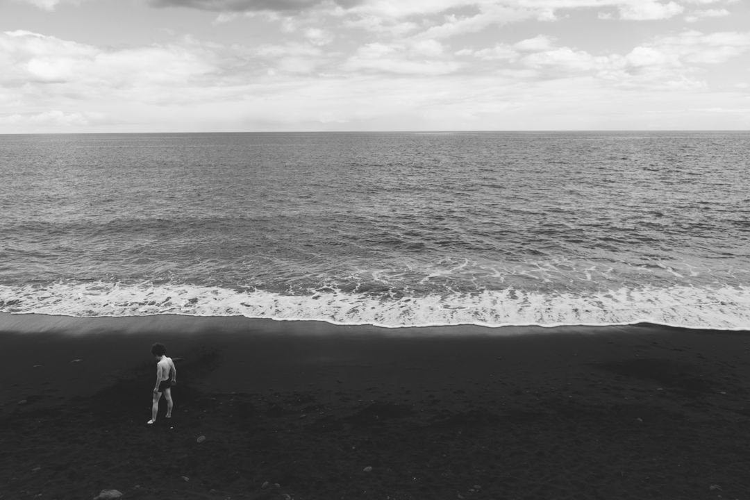 Grayscale Photography of Human Standing on Seashore Near Beach - Free Images, Stock Photos and Pictures on Pikwizard.com