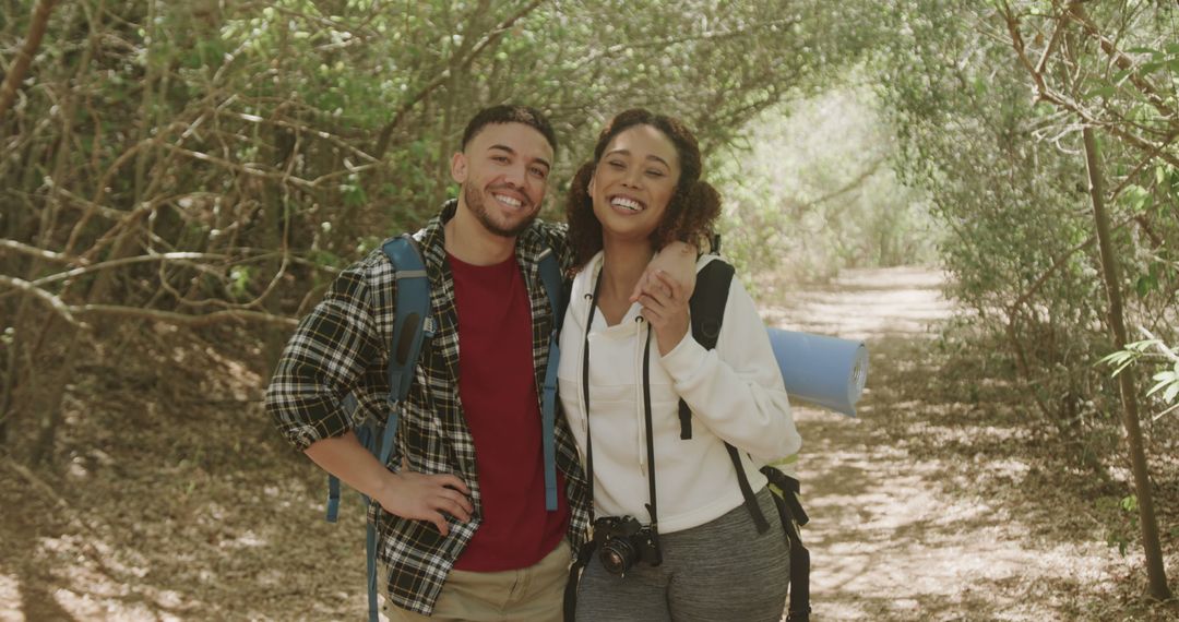 Smiling Couple on Scenic Forest Hiking Adventure