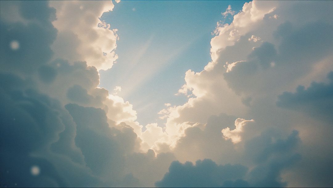 Sun Rays Piercing Dramatic Cumulus Clouds in Blue Sky