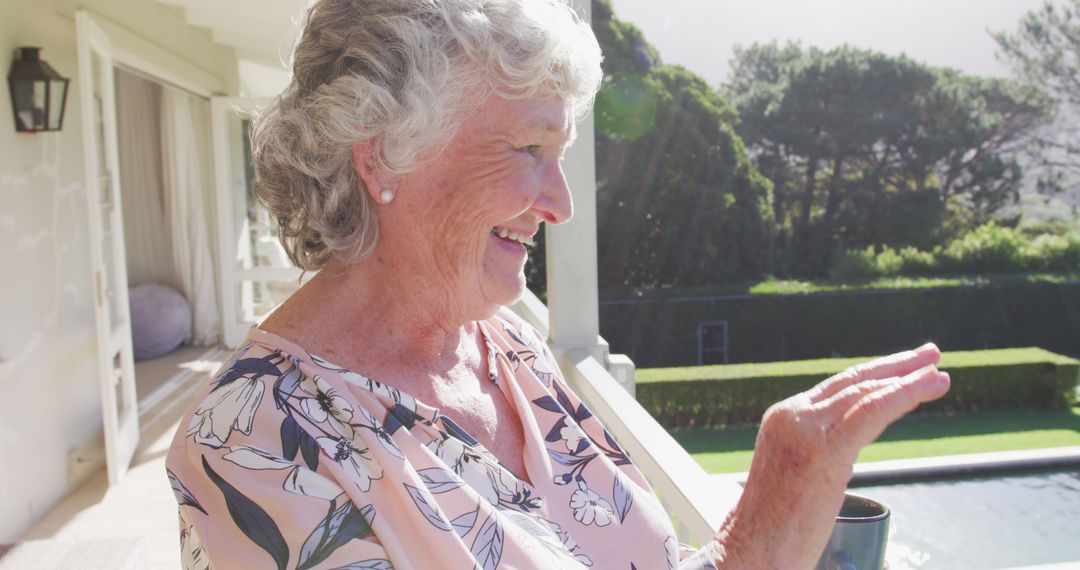 Joyful Senior Woman Enjoying Cup of Coffee on Sunny Porch - Free Images, Stock Photos and Pictures on Pikwizard.com