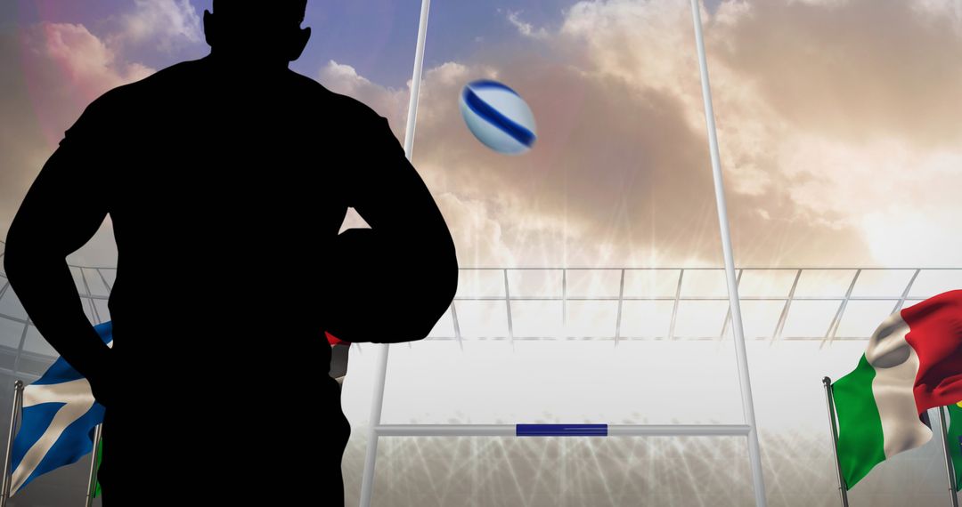 Silhouette of Rugby Player in Stadium with Flags and Ball
