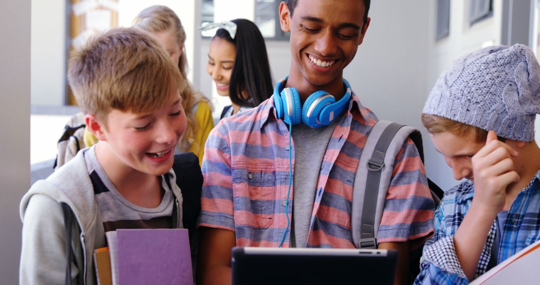 Diverse Group of Students Enjoying Tablet In School Corridor