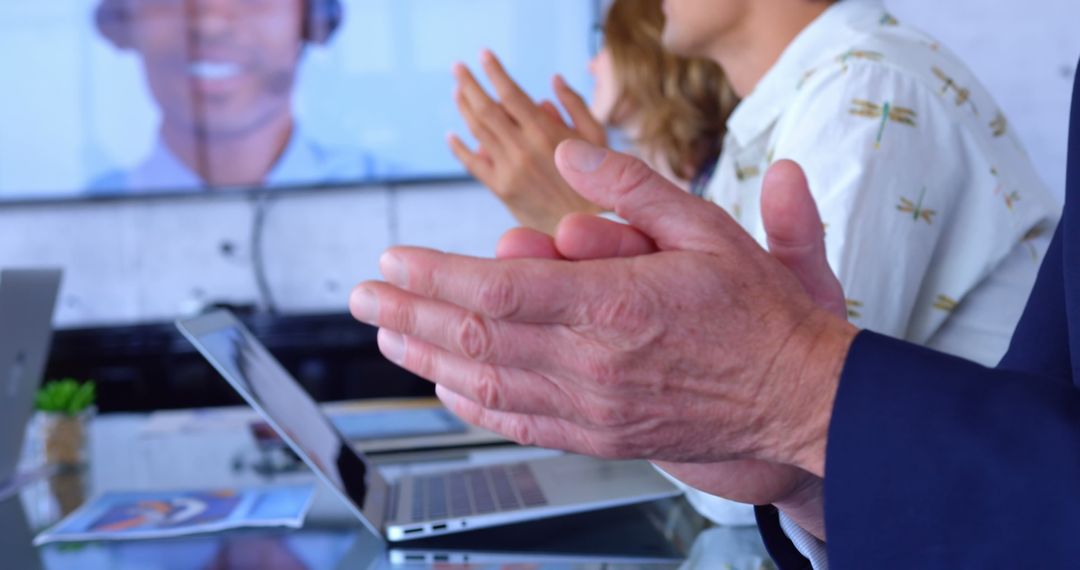 Multi-Ethnic Business Team Clapping During Video Conference in Office