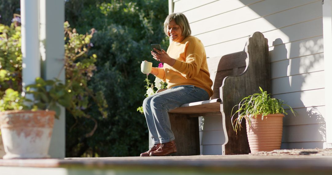 Senior Woman Relaxing on Porch with Coffee and Smartphone - Free Images, Stock Photos and Pictures on Pikwizard.com