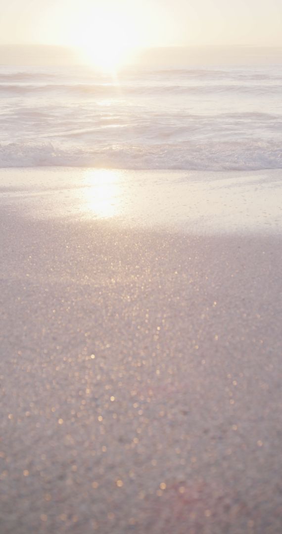 Serene Sunrise on Sandy Beach with Gentle Waves