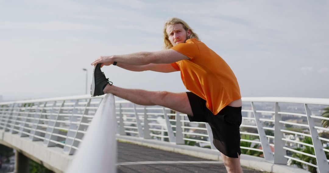 Young Man Stretching on Bridge Before Outdoor Workout - Free Images, Stock Photos and Pictures on Pikwizard.com