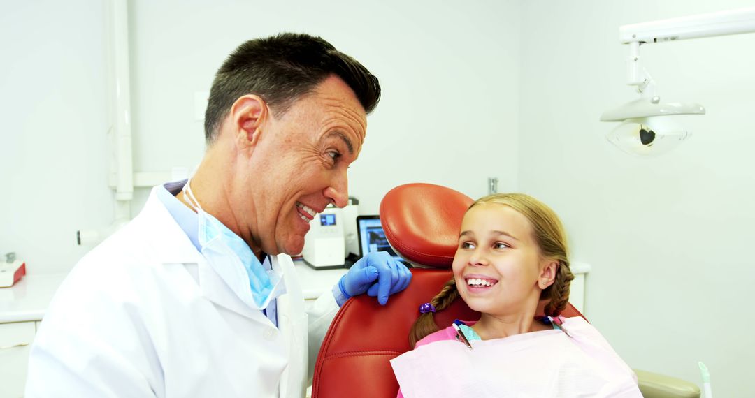 Smiling Child in Dental Chair with Friendly Dentist - Free Images, Stock Photos and Pictures on Pikwizard.com