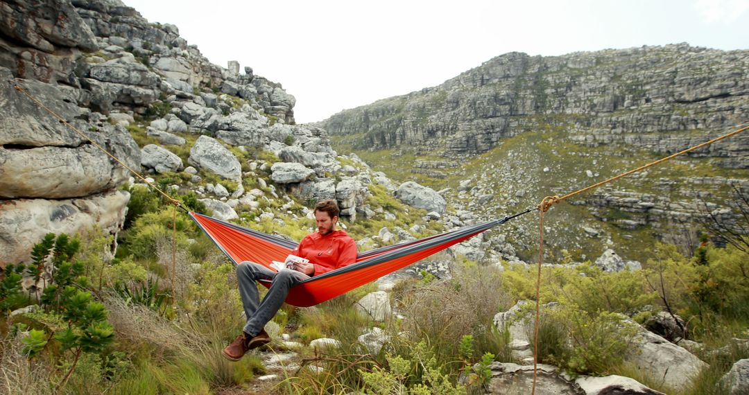 Man Resting in Hammock Amidst Mountainous Terrain - Free Images, Stock Photos and Pictures on Pikwizard.com