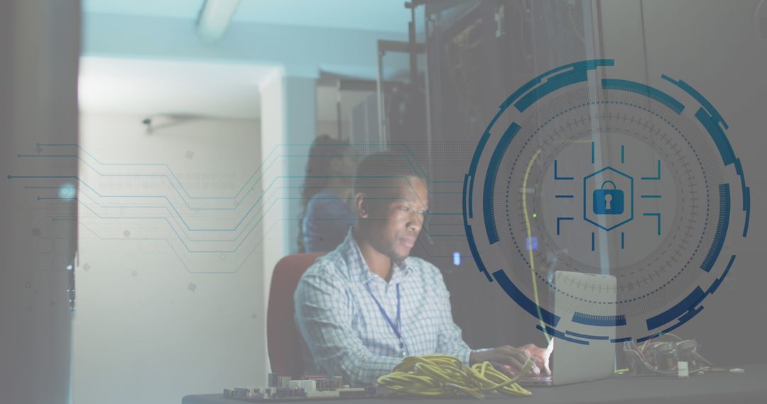 Network Security Engineer Working on Laptop in Data Center