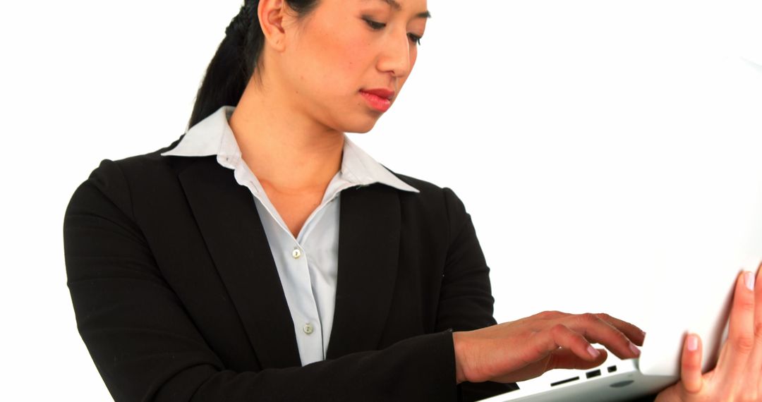 Professional Businesswoman Typing on Laptop Isolated on White Background - Free Images, Stock Photos and Pictures on Pikwizard.com