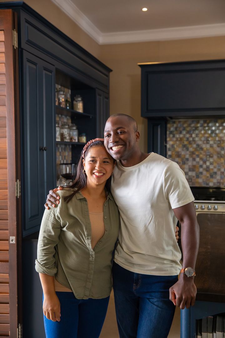 Smiling Couple Hugging in Contemporary Kitchen Setting
