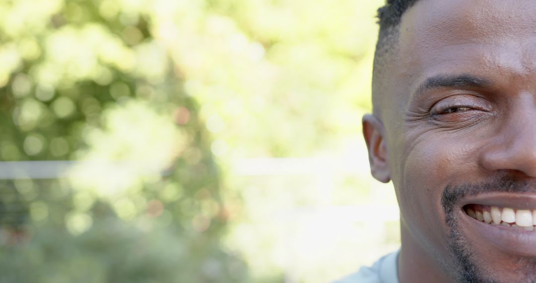Close-Up of Smiling Man Outdoors in Sunlight