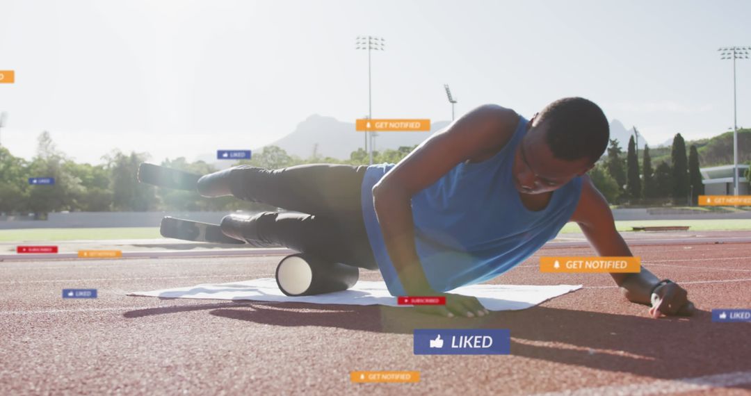 Athlete Using Foam Roller for Muscle Recovery at Track Field