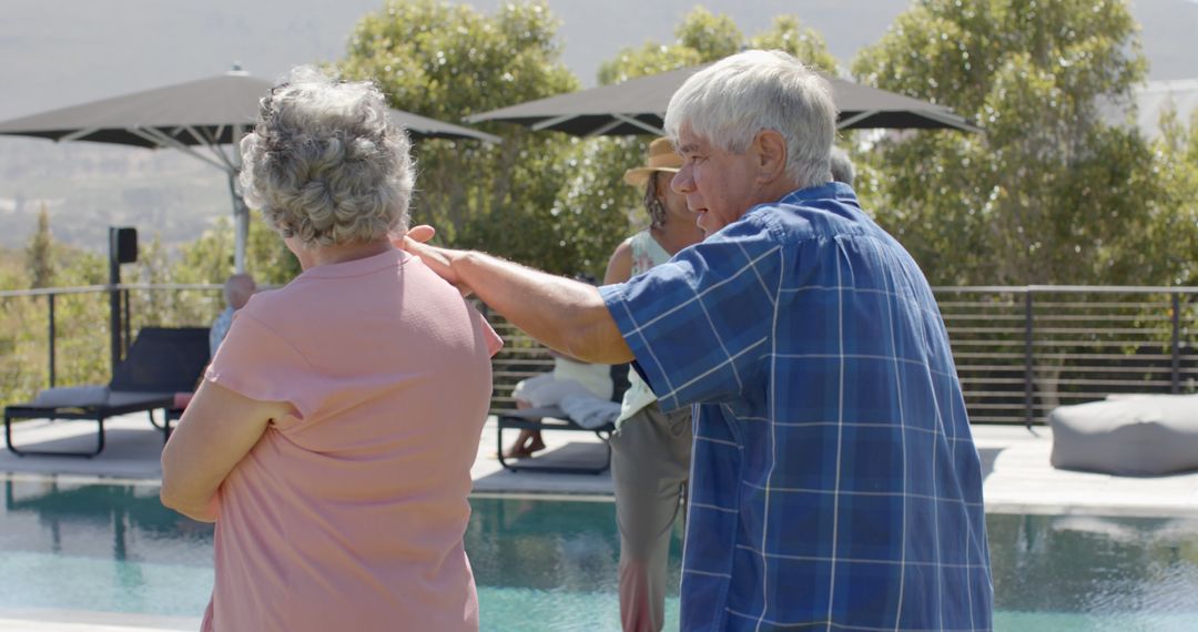 Senior Couple Enjoying Day by Pool at Resort - Free Images, Stock Photos and Pictures on Pikwizard.com