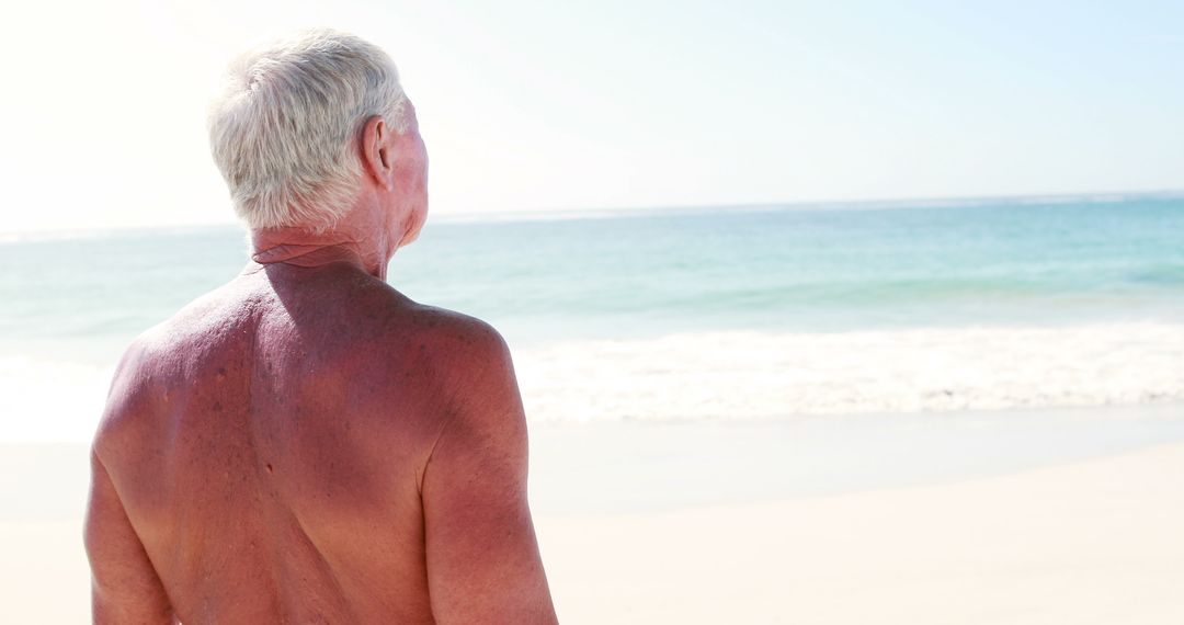 Elderly Man Enjoying Sunny Beach Waves - Free Images, Stock Photos and Pictures on Pikwizard.com