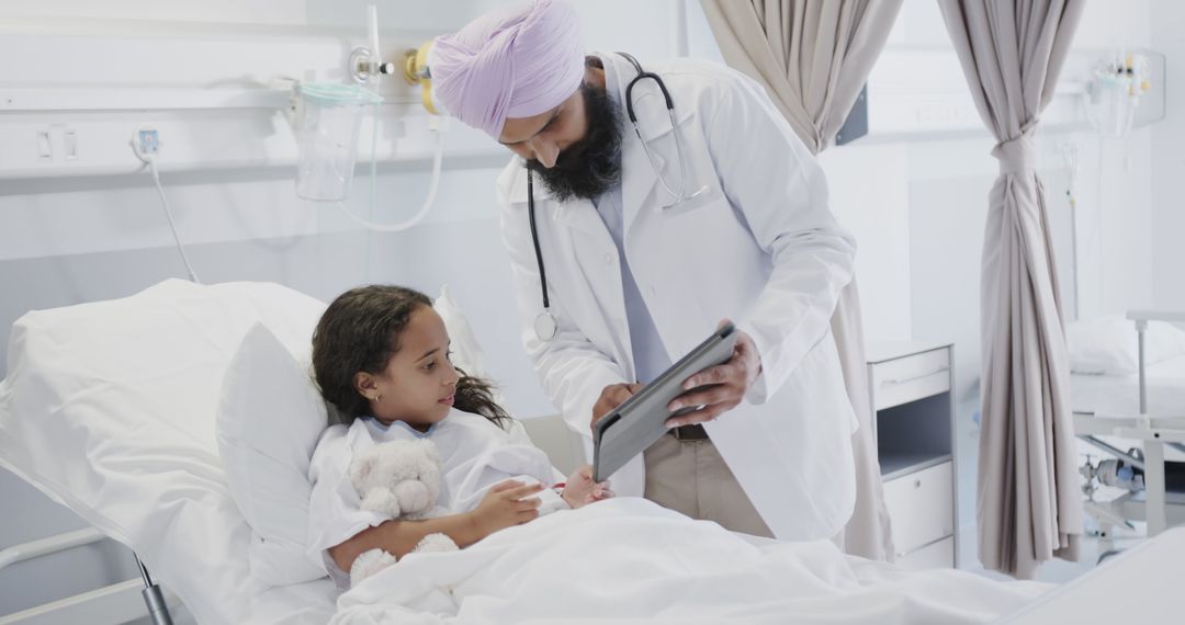 Doctor Consulting Young Patient in Hospital Bed - Free Images, Stock Photos and Pictures on Pikwizard.com