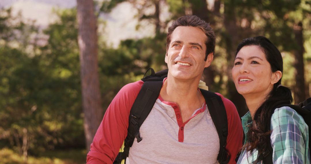 Interracial Couple Smiling During Outdoor Hike in Forest - Free Images, Stock Photos and Pictures on Pikwizard.com