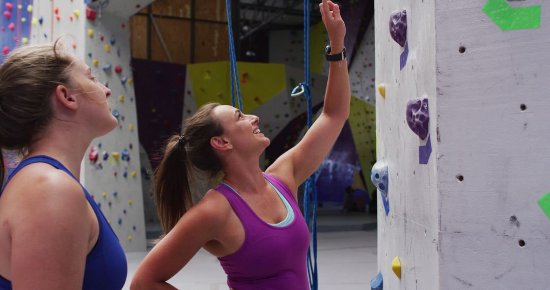 Two Athletic Women Preparing for Indoor Rock Climbing - Free Images, Stock Photos and Pictures on Pikwizard.com