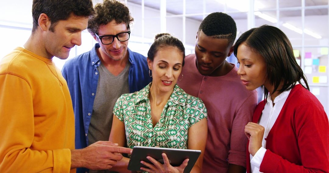 Diverse Team Collaborating with Digital Tablet in Modern Office Space