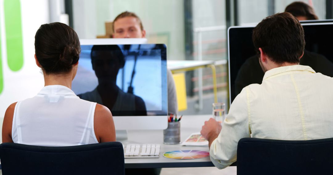 Office Team Collaborating on Desktop Computers