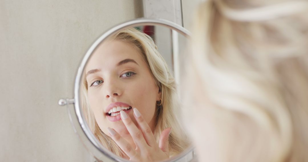 Woman Applying Chapstick in Front of Bathroom Mirror - Free Images, Stock Photos and Pictures on Pikwizard.com